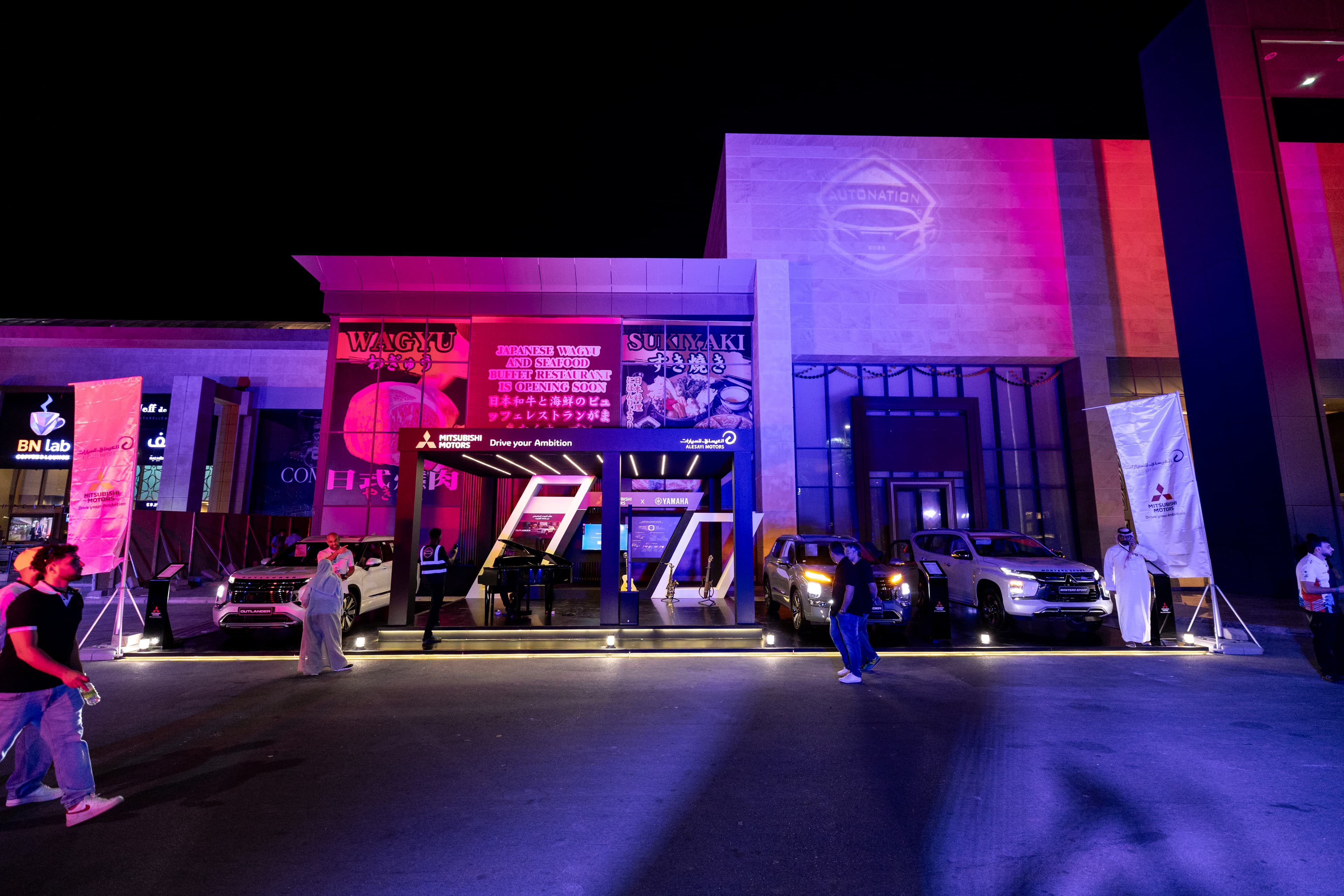 AutoNation automotive event stage surrounded by visitors.